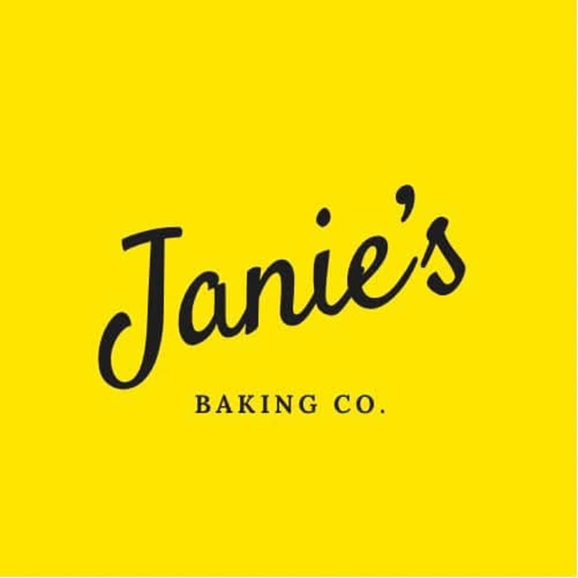 Janie's Baking Co. logo with black script text on a bright yellow background.